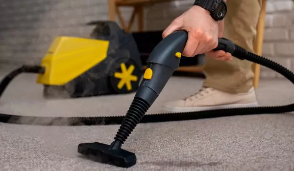 cropped picture of a person cleaning a carpet