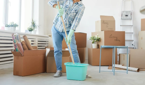 Low section portrait of happy young woman cleaning new house or apartment while moving in