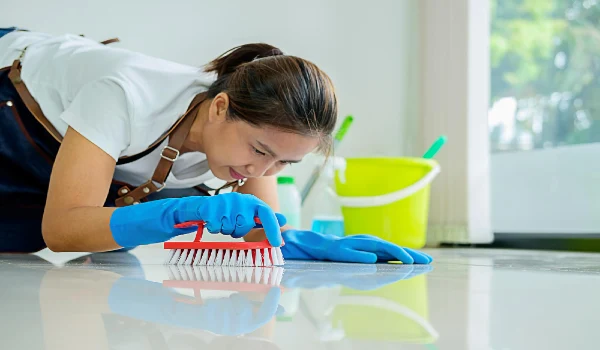 Woman cleaning tiled floor at home