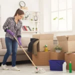 Young woman cleaning home with mop