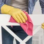 Front view of man cleaning a wooden chair