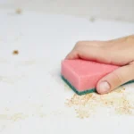 Close-up of woman hand holding paper on table